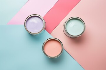 open cans of paint in muted pastel colors on a symmetry color block background, flat lay
