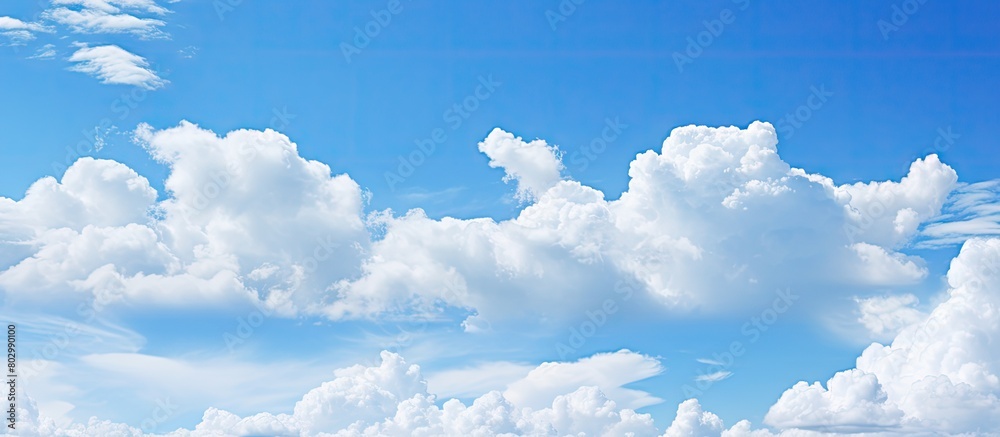 Poster a background image featuring a clear blue sky adorned with fluffy white clouds copy space available