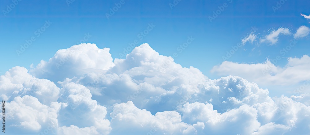 Poster a background image featuring a clear blue sky adorned with fluffy white clouds copy space available