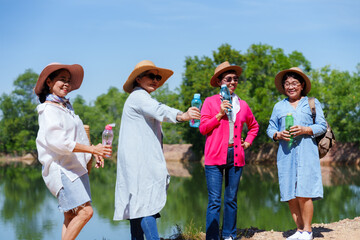 Friends, in light and vibrant attire, smile and toast water bottles, celebrating camaraderie...