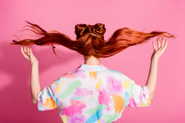 Rear view photo of adorable stunning woman with fluttering silky hair after beauty salon procedure isolated on pink color background