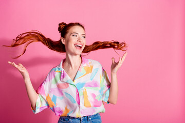 Photo of satisfied funky girl dressed colorful blouse throw up red tails look at offer empty space isolated on pink color background