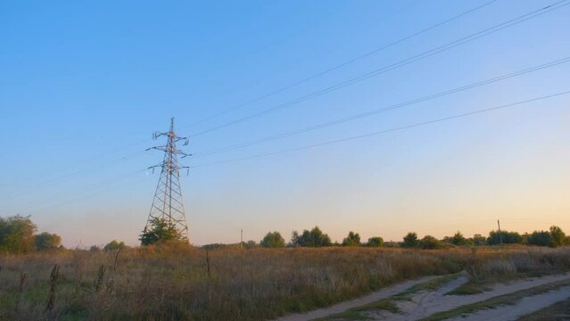 High voltage tower. High-voltage tower in a field against the blue sky. Static shot of a high voltage tower