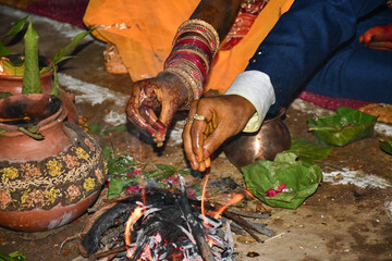 Close of hands of couple getting married, Indian Wedding Male Females during wedding rituals known...