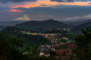 Nilgiris beauty of Ooty tea estates, where emerald-green fields meet the rolling clouds, creating a...