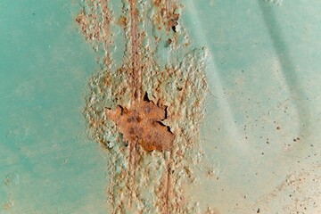 Interesting pattern of rust stains on a painted iron sheet.                               