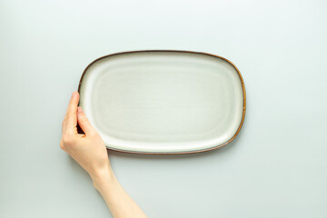Empty ceramic green plate on pastel background, top view