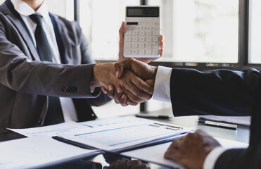 Business partners shaking hands in a meeting. Business and financial cooperation.