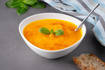 Pumpkin soup on grey background, with copy space for text