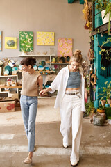 Lesbian couple walk among vibrant art.