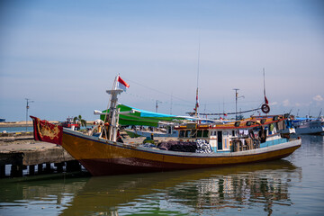 Brown wooden boats anchor at Paotere Traditional Harbour. Its located 4 km north of Makassar City. 