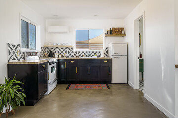 Modern bohemian white black home kitchen with polished concrete floor