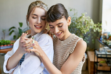 Two young women embracing in a cozy room.