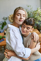Fototapeta premium Two women sharing a heartfelt hug in an art studio.