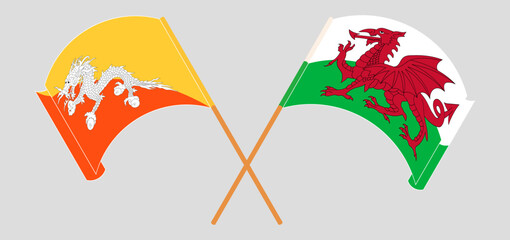 Crossed and waving flags of Bhutan and Wales