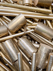 Portrait view of scrap brass bars and rods for recycling or re-use