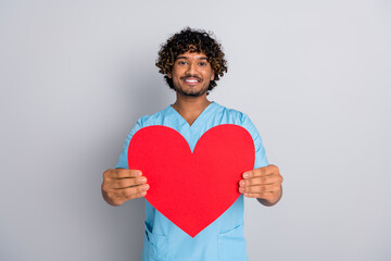 Photo of doctor guy hold red heart demonstrate isolated grey color background