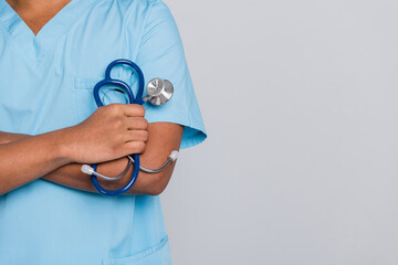 Cropped photo of doctor guy hold stetthoscope with empty space isolated grey color background