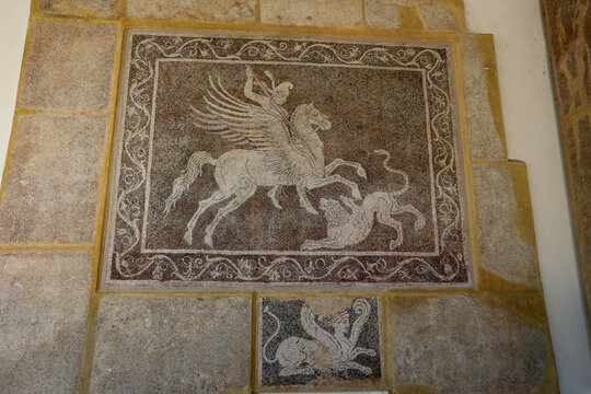 Rhodes, Greece - August 10, 2017: Mosaic depicting a rider fighting a lion at the Archaeological Museum on the island of Rhodes, Greece.