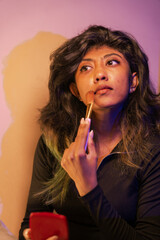 Fototapeta premium A woman is applying makeup with a brush