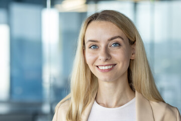 Confident young businesswoman smiling in modern office