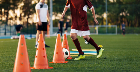 Soccer Training Class. Legs of Children on Football Lesson. Kids Practicing Soccer Skills on School...