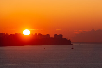 sun is rising over the city of antalya and shinning on the mediterranean sea