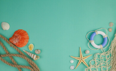 on a delicate green-blue background, shells of different shapes and sizes, a rope and a fishing...