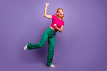 Photo of crazy good mood woman wear trendy pink clothes listening music isolated on purple color background
