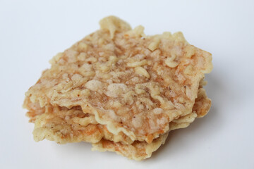 Keripik tempe or tempeh crackers, square shape. Thin slices tempeh, fried with flour dough. Isolated in white background