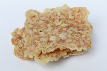 Keripik tempe or tempeh crackers, square shape. Thin slices tempeh, fried with flour dough. Isolated in white background