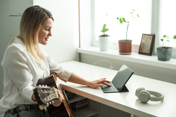 woman holding a guitar with her hands