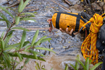 Selective focus, yellow rope rescue bag, riverside, fake flash flood Rescuers carry yellow rope...