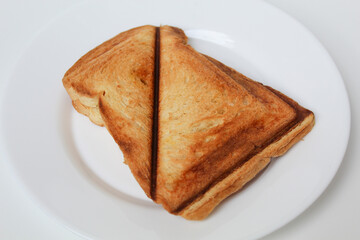 Toast or toasted bread, on white plate, isolated on white background