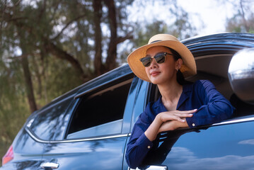Happy beautiful asian woman enjoy travel in summer day, She looking out of car window feeling fresh...