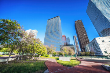 Wide Urban Park Pathway with City Skyscrapers in Distance