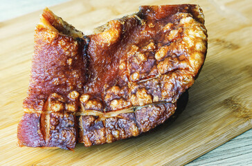 Fried pork ham on a cutting board, side view