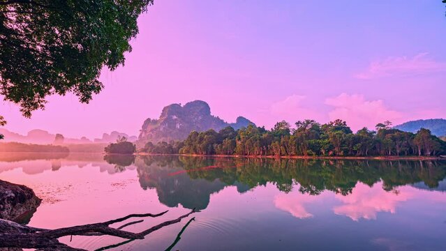 Time lapse Pastel Pink Sunrise over the swamp. Peaceful Seascape over lake Nong Thale Krabi. with Clouds and forest Reflected on Sea Water. Panoramic Horizon Coastal Landscape. Landscape Nature
