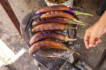 Selective focus purple Eggplant grilled on a charcoal grill