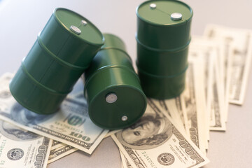 Barrel of crude oil with dollar bills. Close up. Business concept.