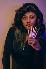 A woman is holding a brush set in her hand