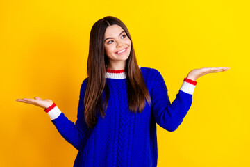 Photo portrait of pretty teen girl hold look compare empty space wear trendy knitwear blue outfit...