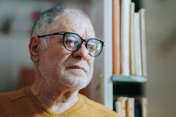 Scholarly Vision Front View of Elderly Man Amid Bookshelves - Powered by Adobe