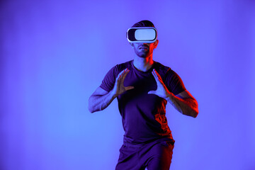 Caucasian man playing basketball while wearing VR headset to enter metaverse or simulated world...