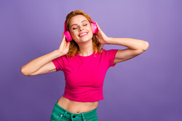 Photo of pretty cute woman wear stylish pink clothes enjoy listening music isolated on purple color background