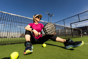 Portrait of attractive woman padel tennis player in outdoor court.
