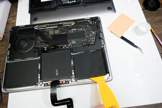 Newcastle UK: 22nd April 2024: A MacBook Pro M1 13 inch broken and ready for repair. interrior parts battery replacement