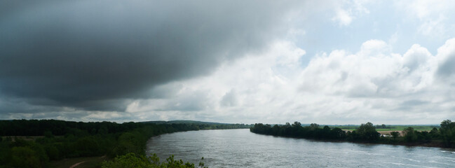 Arkansas River south of Sallisaw, Oklahoma, river is full, storm clouds