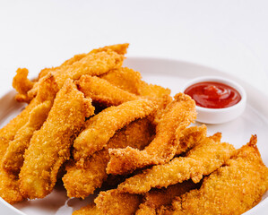 Crispy breaded chicken strips with dipping sauce