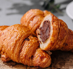 Chocolate-filled croissants on wooden board